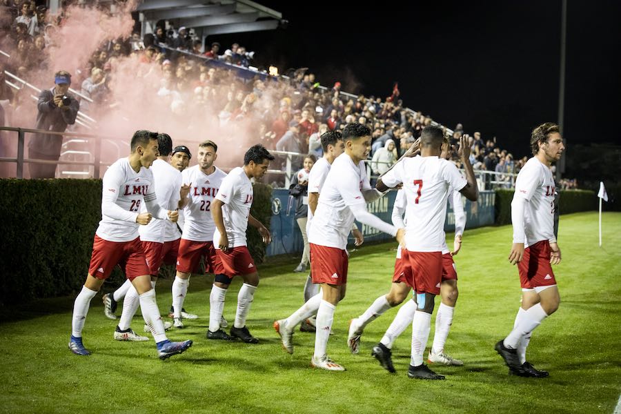 Men's soccer team walking out on the field